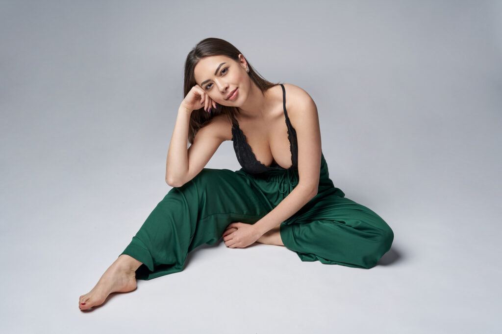 Sensual brunette female in green trousers and top with deep cleavage O-Shot® in Akron, OH